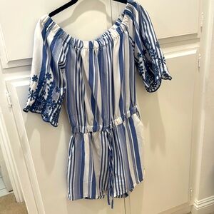 Beautiful Romper/details on sleeves.Can be worn off the shoulder.Slightly used.